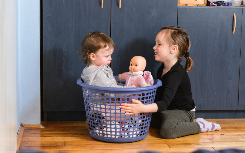 kids playing with laundry basket